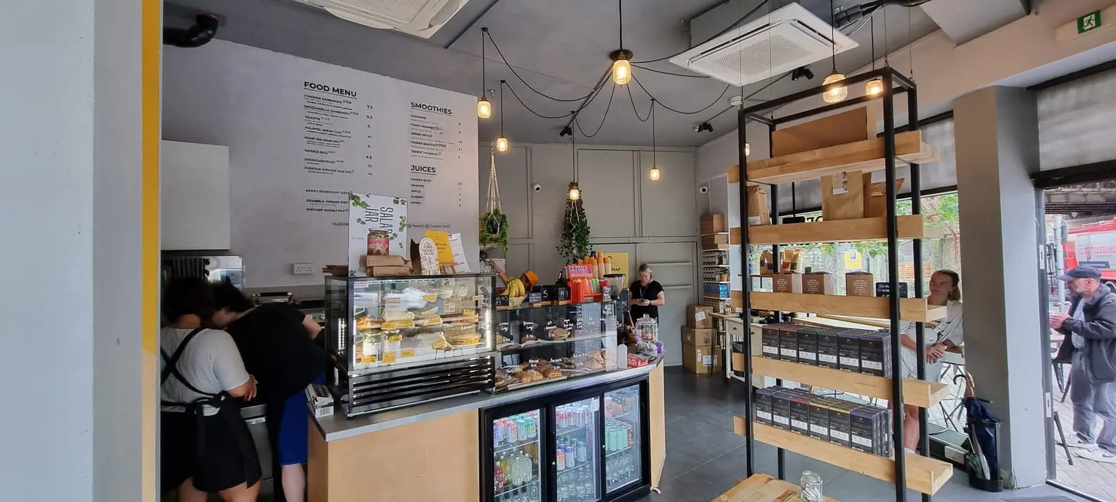 The bright interior of Sendero, with shelving and big windows